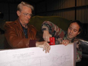 Dave's helping Christina staple the drawing to the plywood jig.